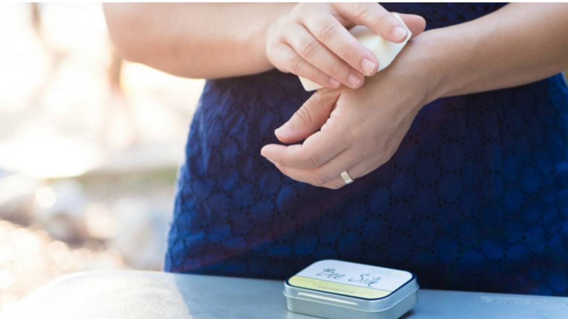 woman applying lotion bar to hands