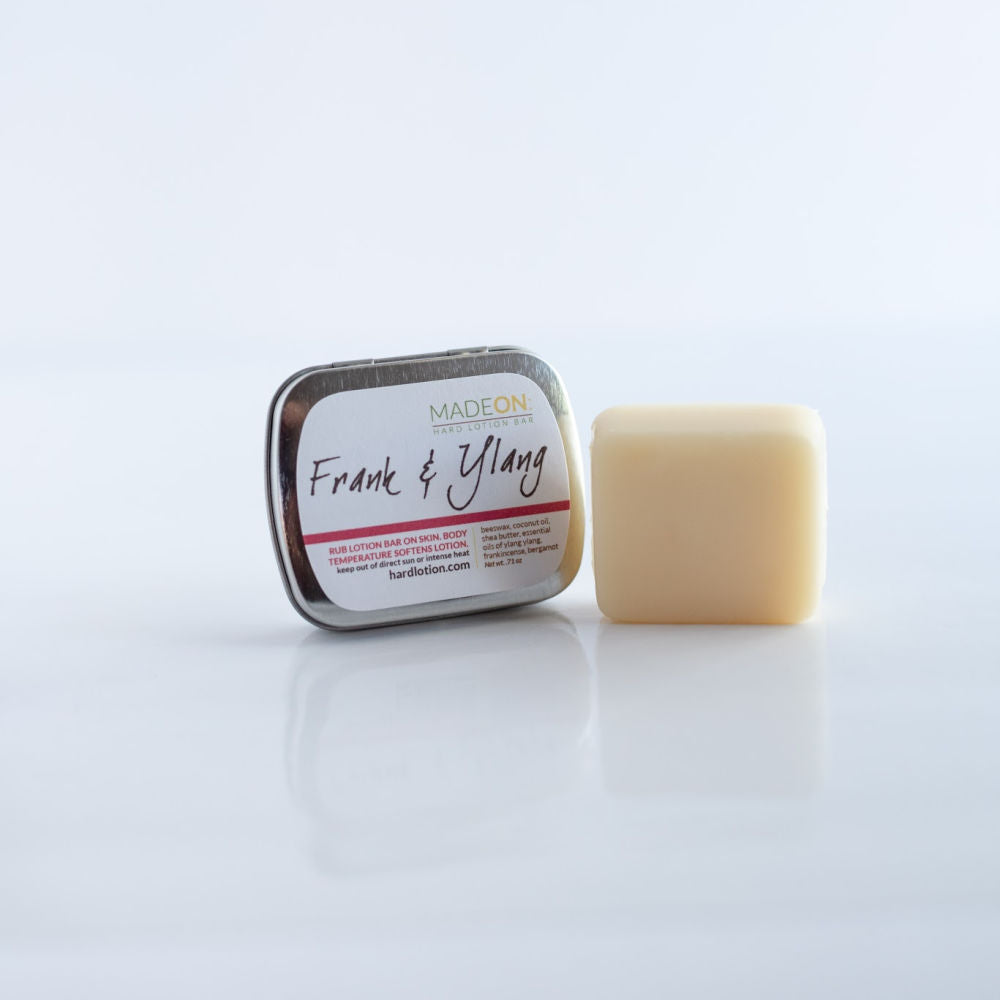 lotion bar outside tin scented with frankincense and ylang ylang essential oils, best for dry skin