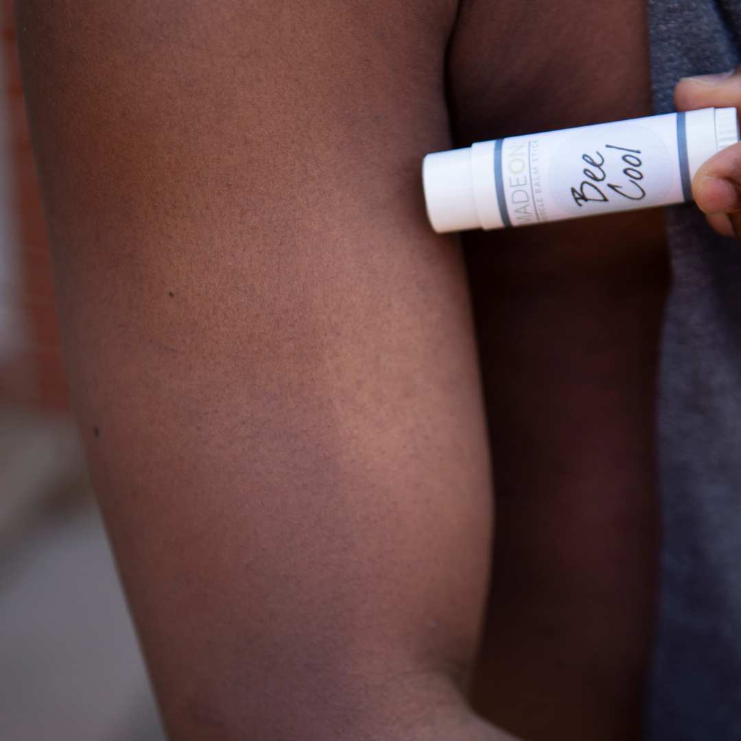 African American Man applying Beecool Muscle Balm to sore muscle