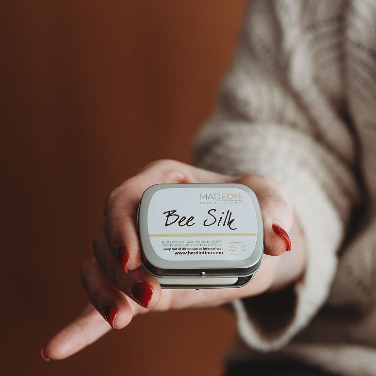 woman holding beesilk lotion bar