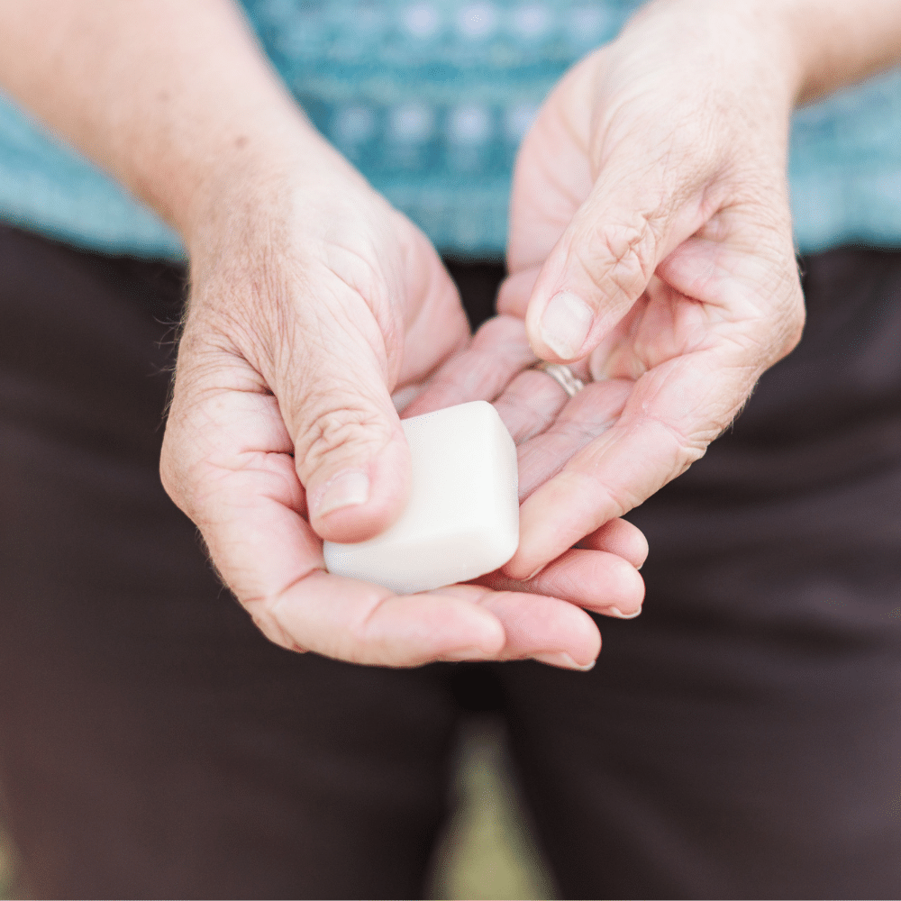 hand holding pocket size lotion bar