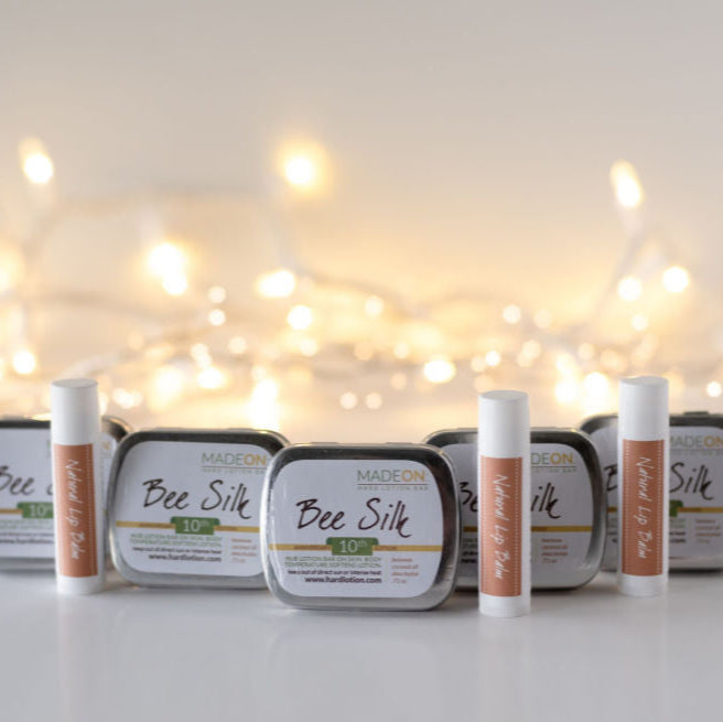 Gift Packs: 5 Beesilk Lotion Bars, 5 Natural lip balms with twinkling lights in the background