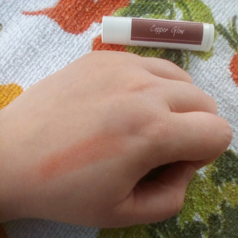 Copper Glow tinted lip balm color on hand.  Iron oxide based mineral lipstick.