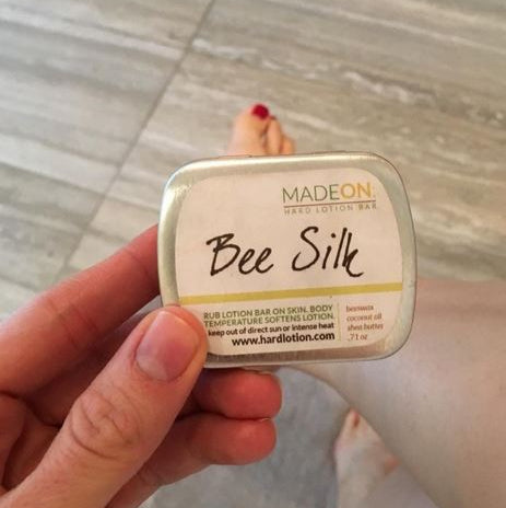 woman holding Beesilk lotion bar for dry skin