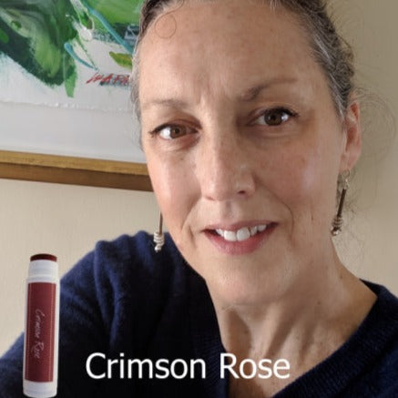 female showing the Crimson Rose tinted lip balm made with iron oxide and only 4 ingredients. Mineral lipstick.