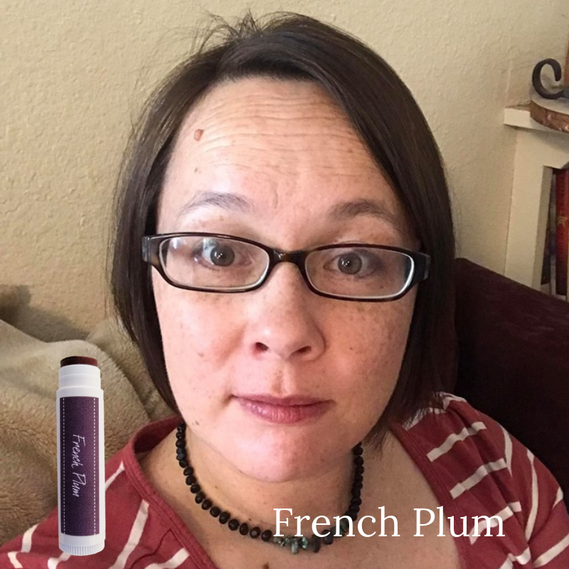 Woman wearing French Plum Tinted Lip Balm. Iron oxide based mineral lipstick.