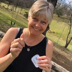 woman holding beesilk hard lotion bar for dry skin