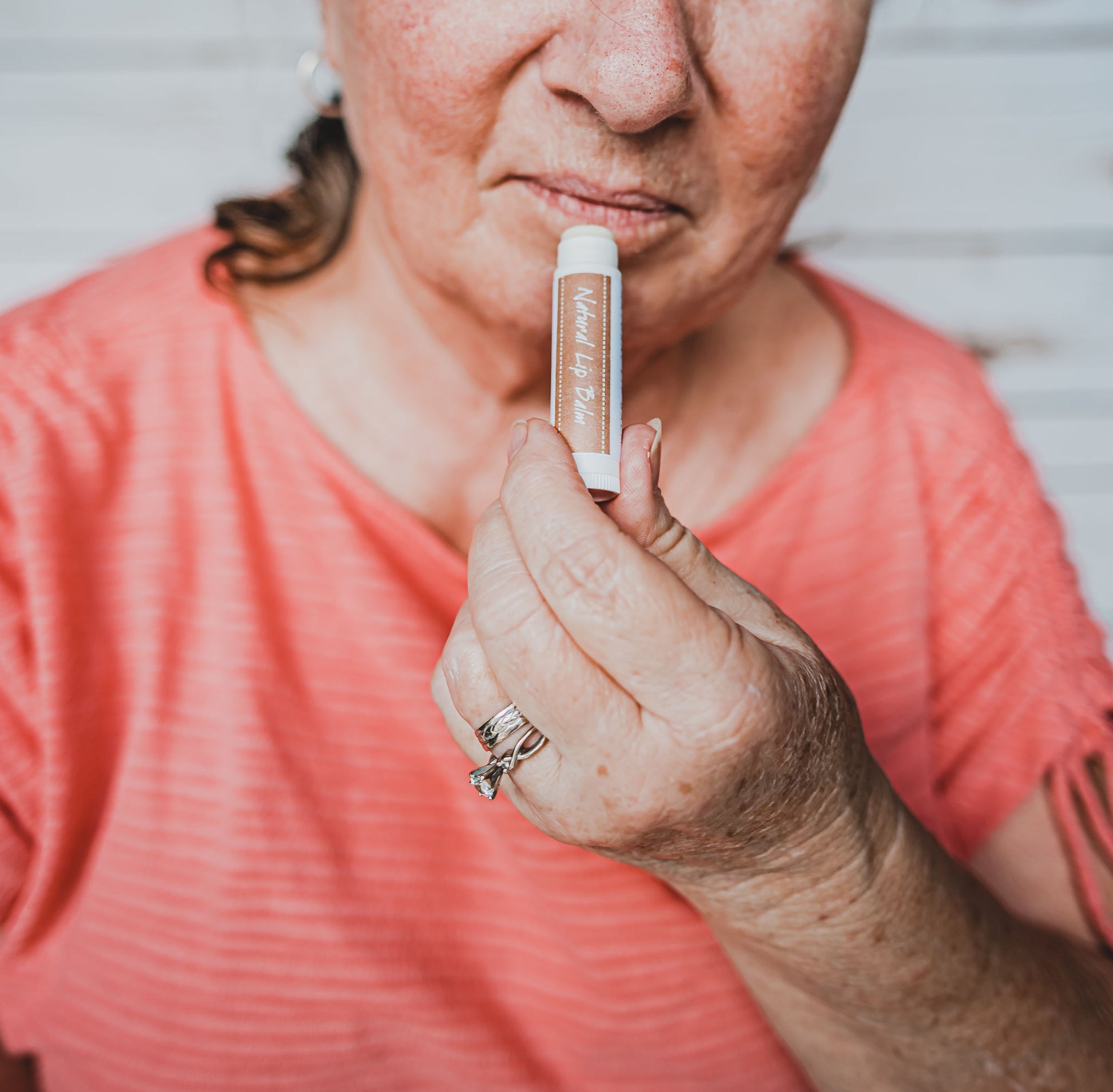 woman applying lip balm