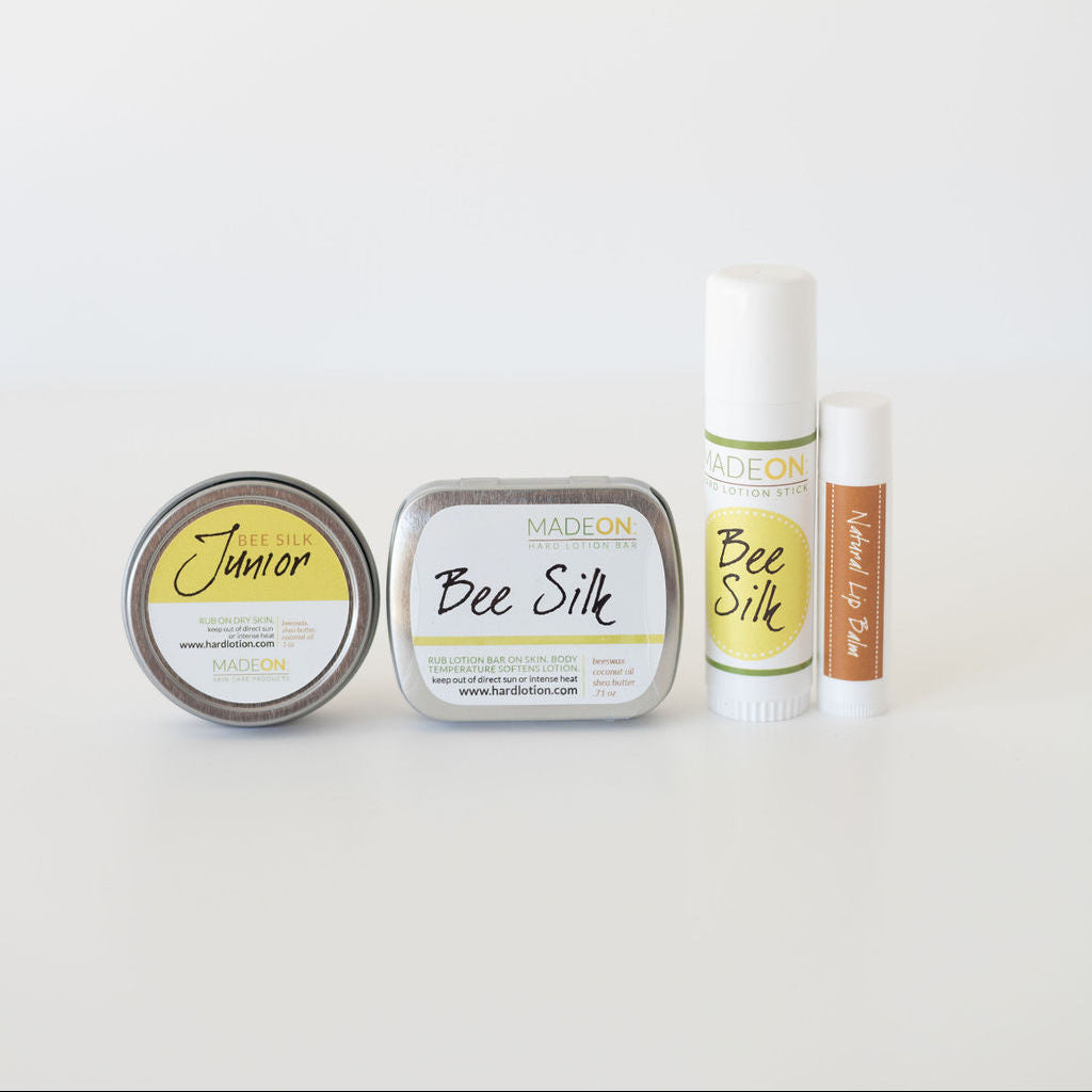 Beesilk in emollient, lotion stick, lotion bar and lip balm form against white background