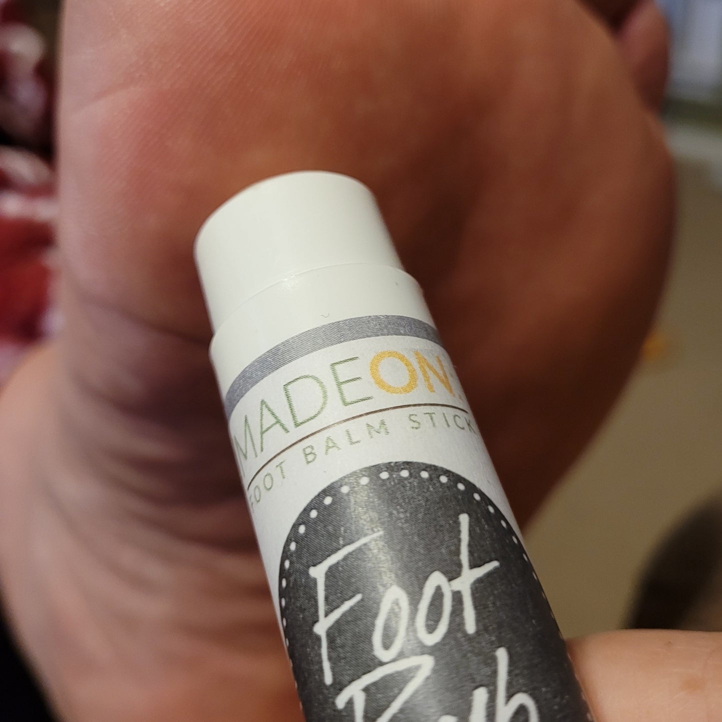 Foot Rub Lotion Stick applied to foot skin issues on bottom of foot