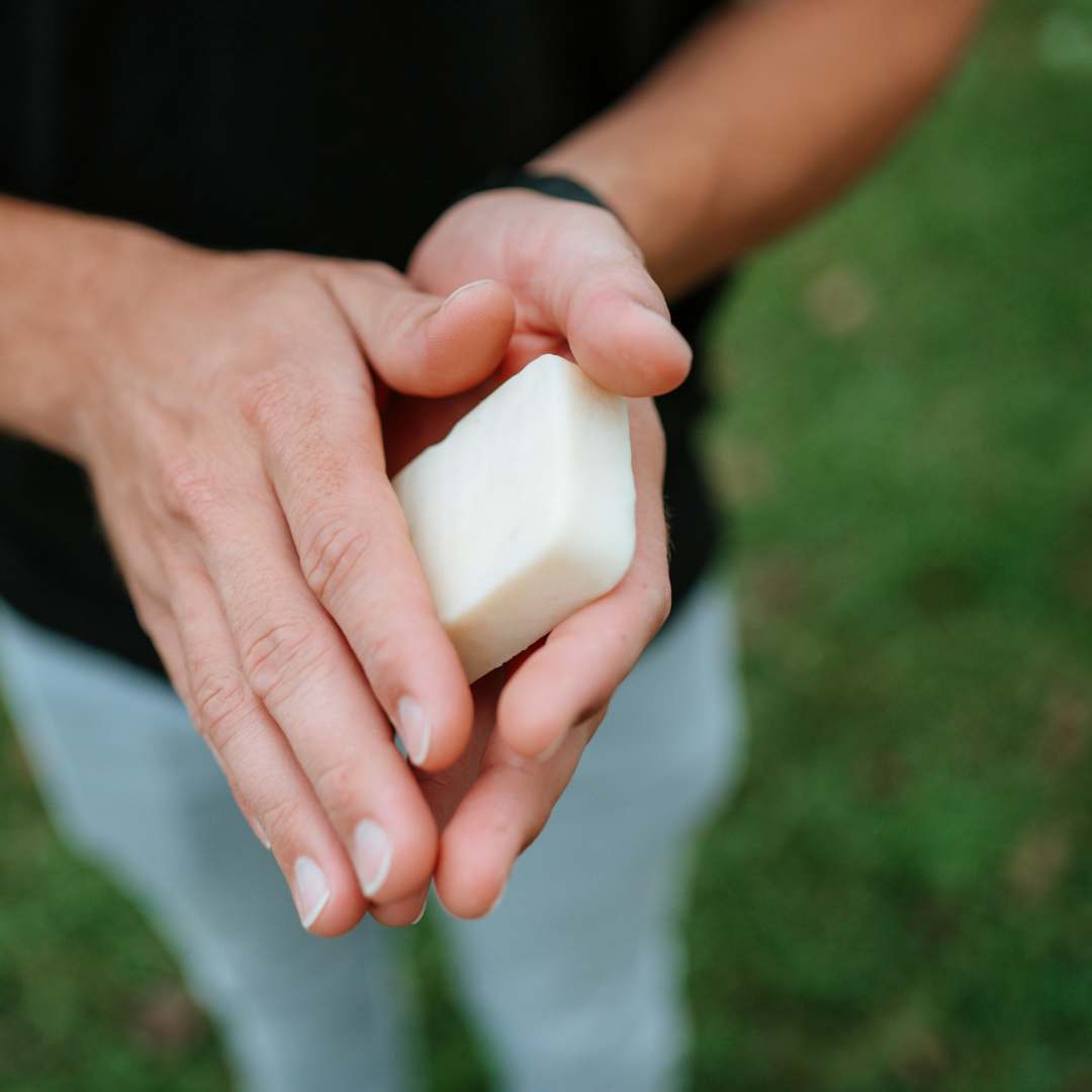 Man applying lotion bar to hands