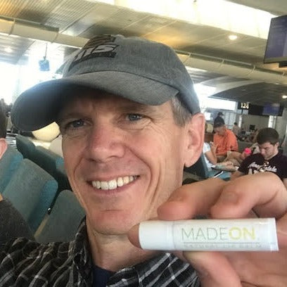 man with lip balm in airport