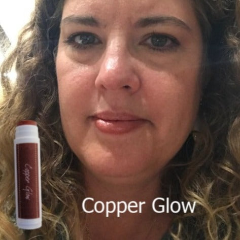 Female showing Copper Glow tinted lip balm made with iron oxide and only 4 ingredients