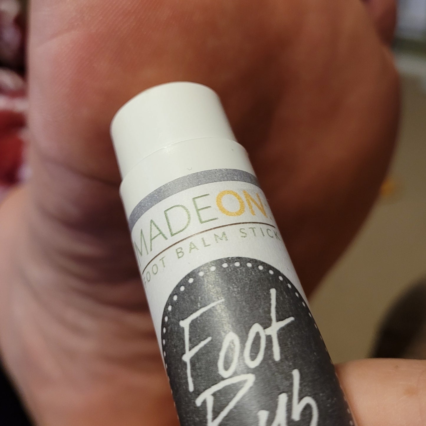 foot rub lotion stick applied to bottom of feet