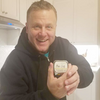 man holding a beesilk lotion bar in tin